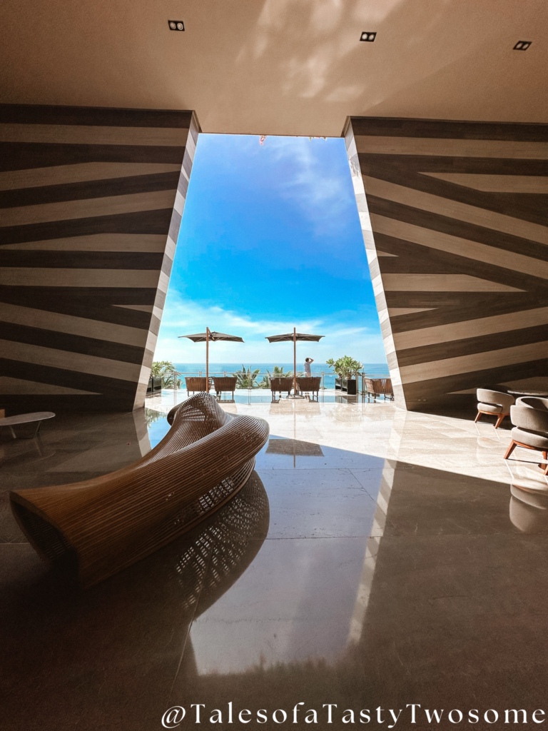 Grand entrance of Grand Velas Los Cabos with modern architecture and ocean in the background